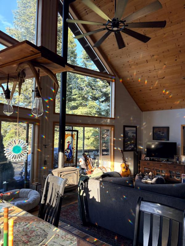 Tall windows and a high ceiling casting rainbow light across a great room