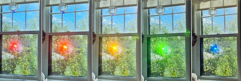 A series of photos of the same suncatcher in the same window showing the dramatic flash of colored light as the sun shifts